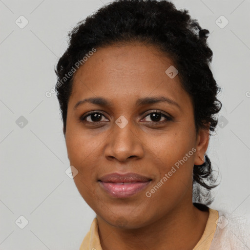 Joyful black young-adult female with short  black hair and brown eyes