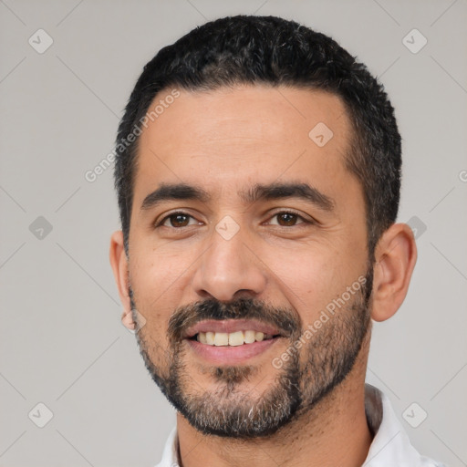 Joyful latino young-adult male with short  black hair and brown eyes