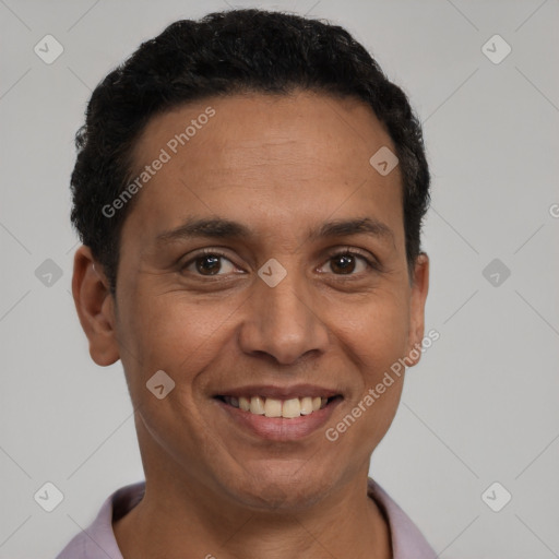 Joyful latino adult male with short  brown hair and brown eyes