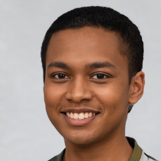 Joyful black young-adult male with short  brown hair and brown eyes