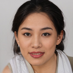 Joyful asian young-adult female with medium  brown hair and brown eyes