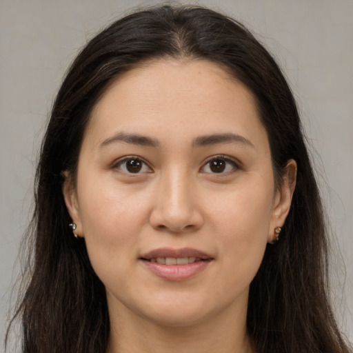 Joyful white young-adult female with long  brown hair and brown eyes