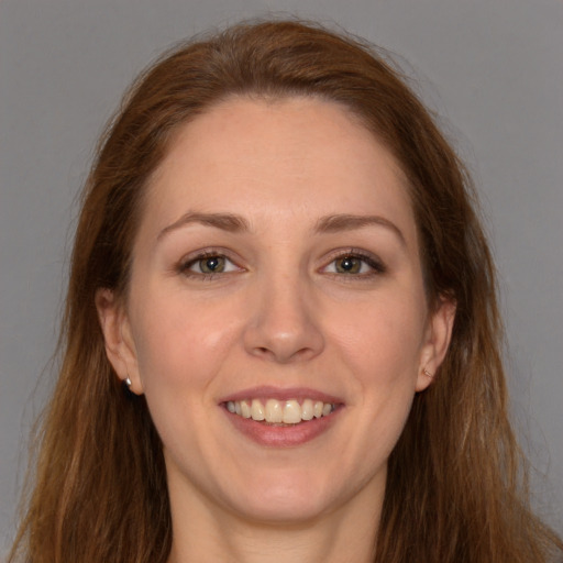 Joyful white young-adult female with long  brown hair and brown eyes