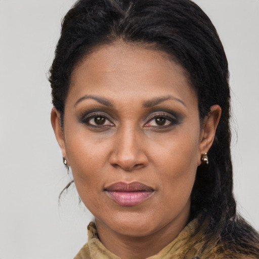 Joyful black adult female with long  brown hair and brown eyes