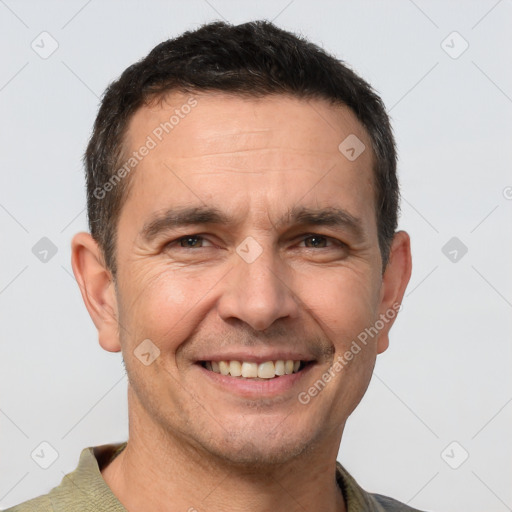 Joyful white adult male with short  brown hair and brown eyes