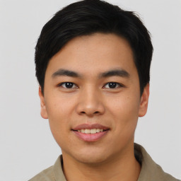 Joyful asian young-adult male with short  black hair and brown eyes