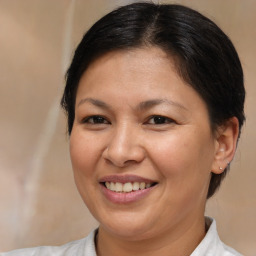 Joyful white adult female with medium  brown hair and brown eyes