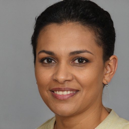 Joyful latino young-adult female with short  brown hair and brown eyes