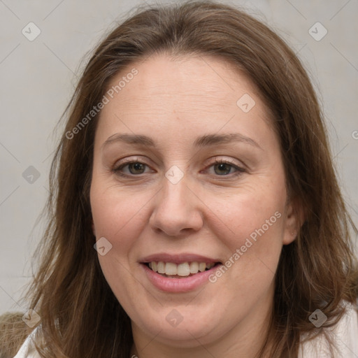 Joyful white adult female with long  brown hair and brown eyes