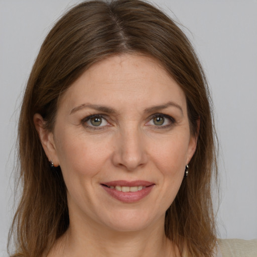 Joyful white adult female with medium  brown hair and grey eyes