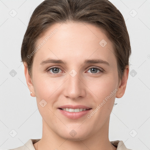 Joyful white young-adult female with short  brown hair and grey eyes