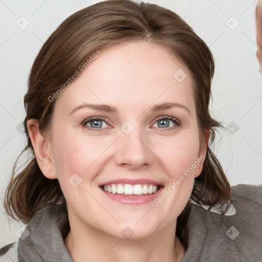 Joyful white young-adult female with medium  brown hair and blue eyes