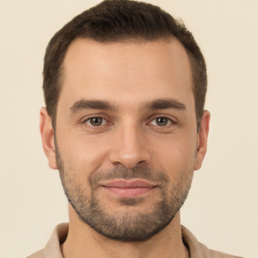 Joyful white young-adult male with short  brown hair and brown eyes