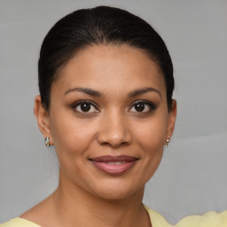 Joyful latino young-adult female with short  brown hair and brown eyes