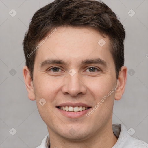 Joyful white young-adult male with short  brown hair and grey eyes