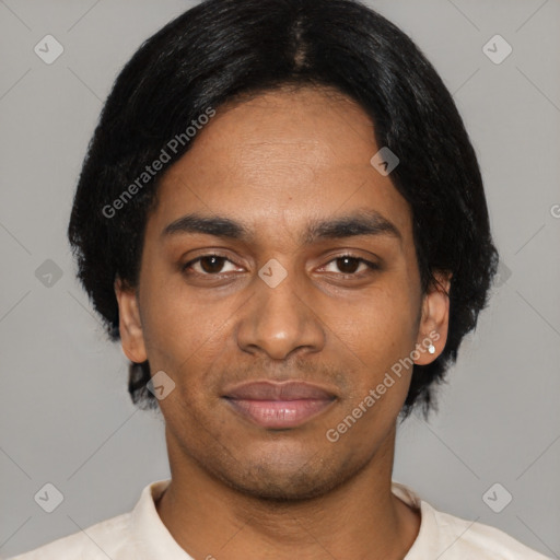 Joyful black young-adult male with short  black hair and brown eyes