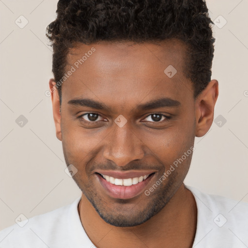 Joyful black young-adult male with short  brown hair and brown eyes