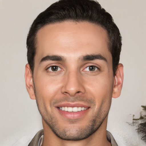 Joyful white young-adult male with short  black hair and brown eyes