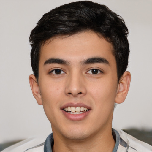 Joyful white young-adult male with short  black hair and brown eyes