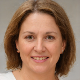 Joyful white adult female with medium  brown hair and brown eyes