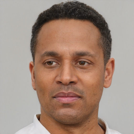 Neutral latino adult male with short  black hair and brown eyes