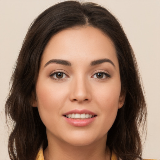 Joyful white young-adult female with long  brown hair and brown eyes