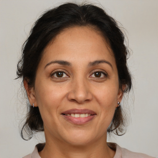 Joyful white adult female with medium  brown hair and brown eyes