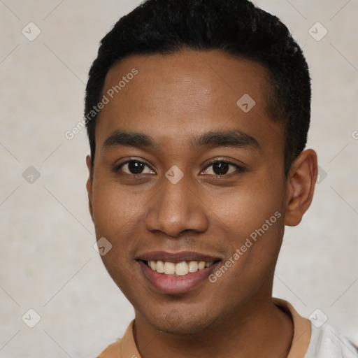 Joyful black young-adult male with short  black hair and brown eyes