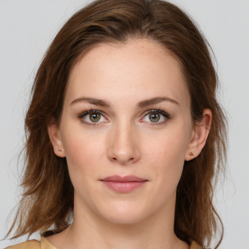 Joyful white young-adult female with medium  brown hair and green eyes