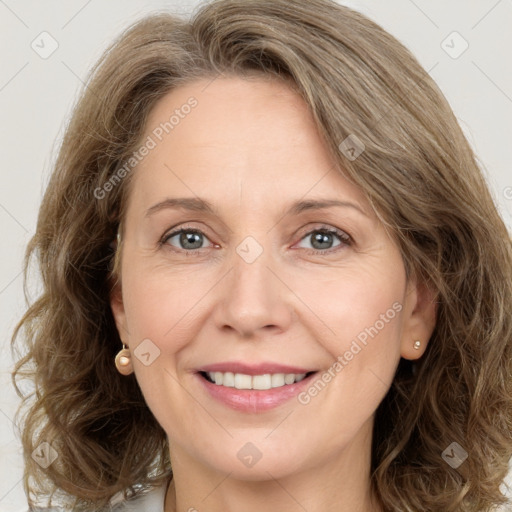 Joyful white adult female with long  brown hair and brown eyes