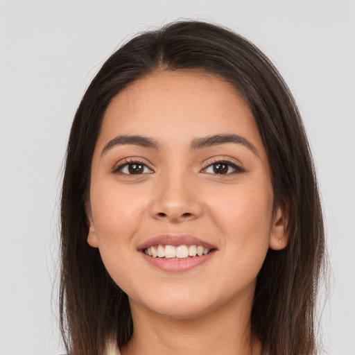 Joyful white young-adult female with long  brown hair and brown eyes