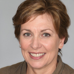 Joyful white adult female with medium  brown hair and blue eyes