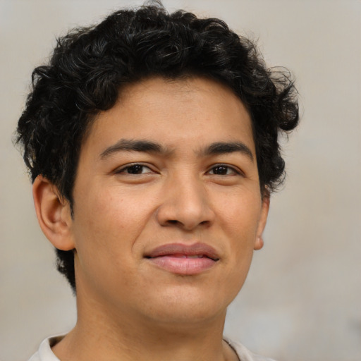 Joyful latino young-adult male with short  brown hair and brown eyes