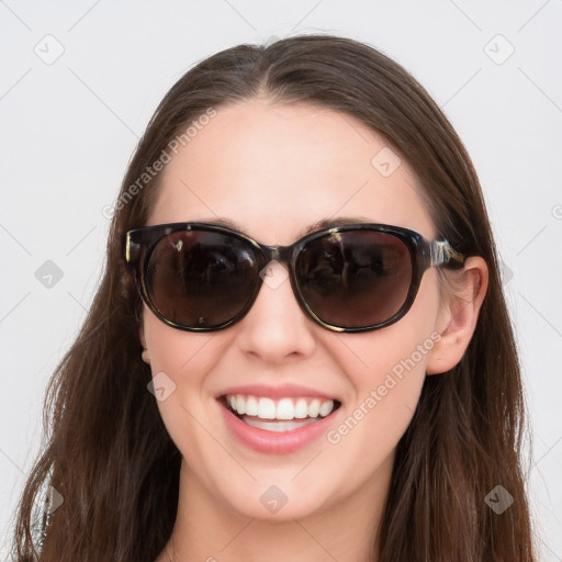 Joyful white young-adult female with long  brown hair and blue eyes