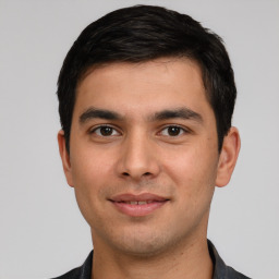 Joyful white young-adult male with short  black hair and brown eyes