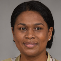 Joyful black young-adult female with medium  brown hair and brown eyes