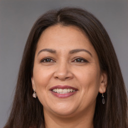 Joyful white adult female with long  brown hair and brown eyes