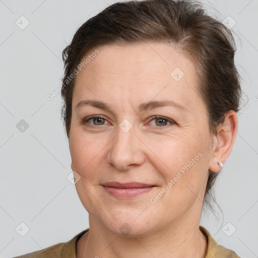 Joyful white adult female with short  brown hair and brown eyes