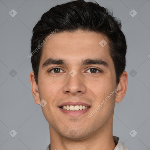 Joyful white young-adult male with short  black hair and brown eyes