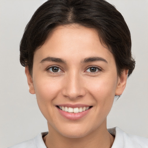 Joyful white young-adult female with short  brown hair and brown eyes