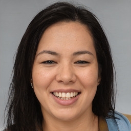 Joyful asian young-adult female with long  brown hair and brown eyes