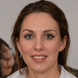 Joyful white young-adult female with medium  brown hair and blue eyes