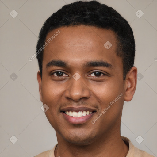 Joyful black young-adult male with short  black hair and brown eyes