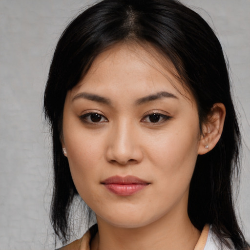 Joyful white young-adult female with medium  black hair and brown eyes