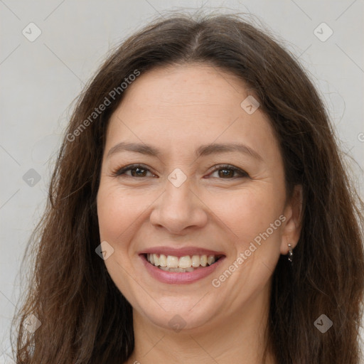 Joyful white adult female with long  brown hair and brown eyes