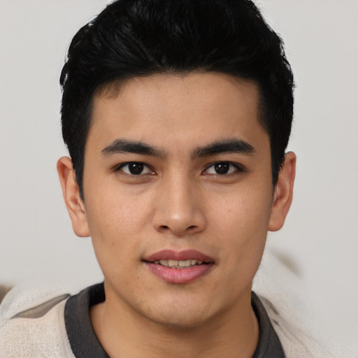 Joyful asian young-adult male with short  black hair and brown eyes