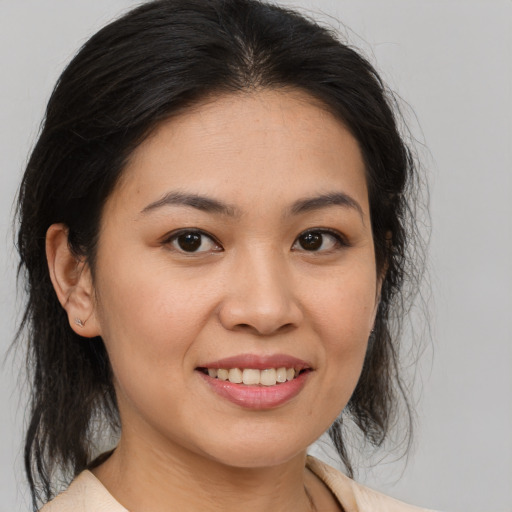 Joyful white young-adult female with medium  brown hair and brown eyes