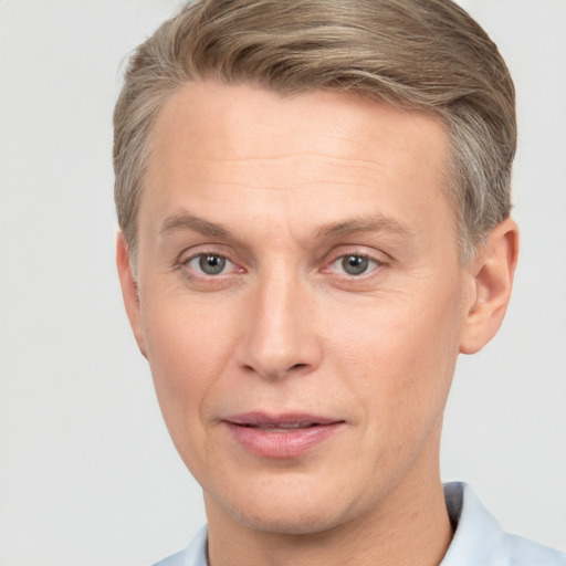 Joyful white adult male with short  brown hair and grey eyes