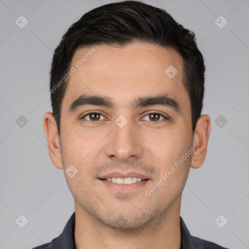 Joyful white young-adult male with short  black hair and brown eyes