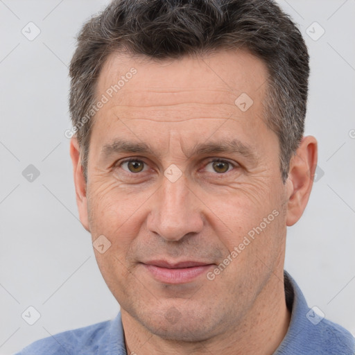 Joyful white adult male with short  brown hair and brown eyes